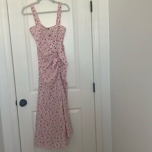 The brand is a Likely long dress with a pink floral pattern in new condition.